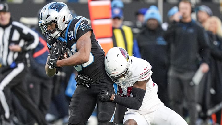 Dec 22, 2024; Charlotte, North Carolina, USA; Carolina Panthers running back Chuba Hubbard (30) tries to evade Arizona Cardinals safety Jalen Thompson (34) during the second half at Bank of America Stadium. Dec 22, 2024; Charlotte, North Carolina, USA; Carolina Panthers running back Chuba Hubbard (30) tries to evade Arizona Cardinals safety Jalen Thompson (34) during the second half at Bank of America Stadium.