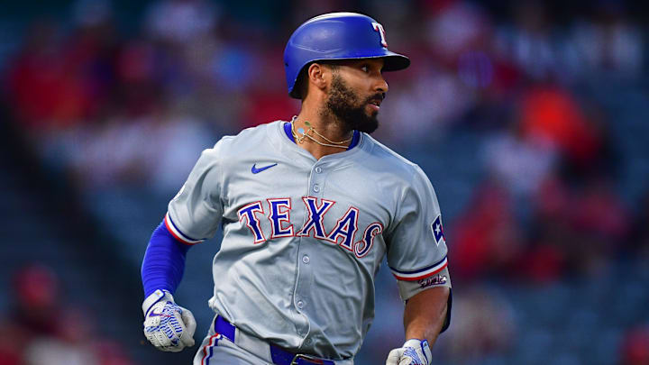 Sep 27, 2024; Anaheim, California, USA; Texas Rangers second baseman Marcus Semien (2) runs after hitting a single against the Los Angeles Angels during the first inning at Angel Stadium. Mandatory Credit: Gary A. Vasquez-Imagn Images