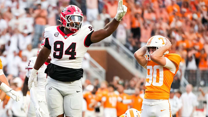 Tennessee place kicker Max Gilbert (90) holds his helmet in disbelief as Georgia defensive lineman Xzavier McLeod (94) celebrates Gilbert's missed field goal in the final seconds of a college football game between Tennessee and Georgia at Neyland Stadium in Knoxville, Tenn., on Sept. 13, 2025.