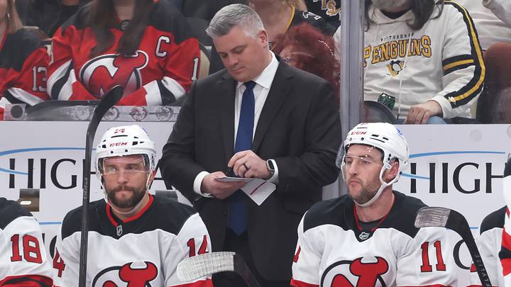 Jan 8, 2026; Pittsburgh, Pennsylvania, USA;  New Jersey Devils head coach Sheldon Keefe makes a note on the bench against the Pittsburgh Penguins during the first period at PPG Paints Arena. Mandatory Credit: Charles LeClaire-Imagn Images
