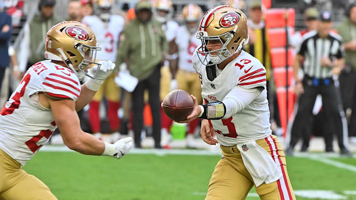 Nov 16, 2025; Glendale, Arizona, USA; San Francisco 49ers quarterback Brock Purdy (13) hands off the ball in the first half against the Arizona Cardinals at State Farm Stadium. Mandatory Credit: Matt Kartozian-Imagn Images