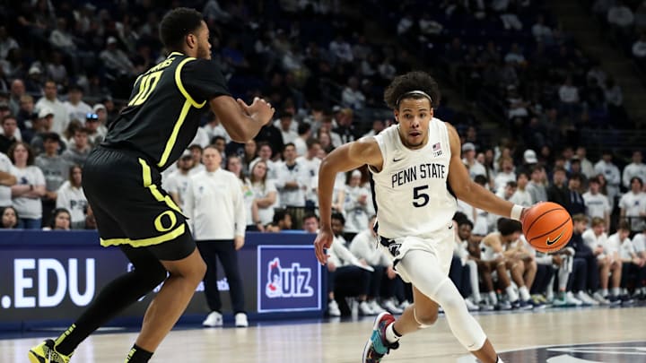 Penn State's Puff Johnson dribbles the ball toward the basket as Oregon Ducks forward Kwame Evans Jr. defends during the first half at Bryce Jordan Center. 