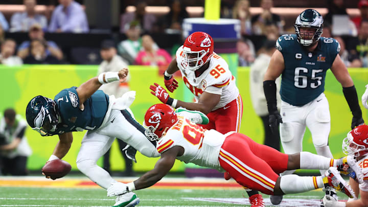 Feb 9, 2025; New Orleans, LA, USA; Philadelphia Eagles quarterback Jalen Hurts (1) is tackled by Kansas City Chiefs defensive tackle Tershawn Wharton (98) in the second quarter in Super Bowl LIX at Ceasars Superdome. Mandatory Credit: Mark J. Rebilas-Imagn Images