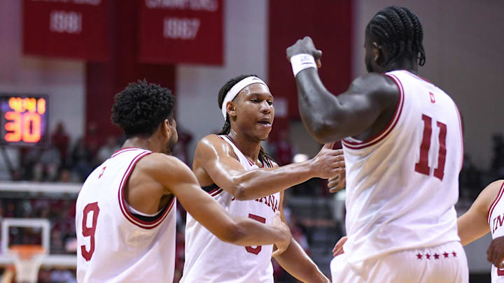 Indiana's Kanaan Carlyle (9), Malik Reneau (5) and Oumar Ballo (11) celebrate against Minnesota at Simon Skjodt Assembly Hall. 