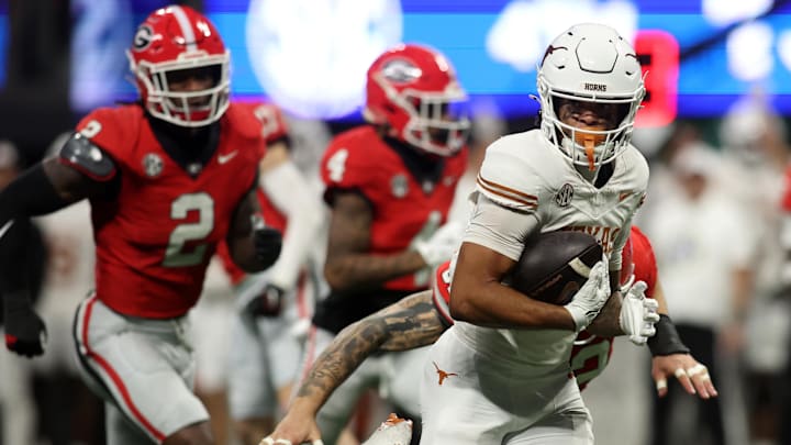 Dec 7, 2024; Atlanta, GA, USA; Texas Longhorns wide receiver DeAndre Moore Jr. (0) makes a touchdown catch against the Georgia Bulldogs during the second half in the 2024 SEC Championship game at Mercedes-Benz Stadium. Mandatory Credit: Brett Davis-Imagn Images