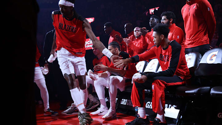 Mar 9, 2025; Portland, Oregon, USA; Portland Trail Blazers guard Anfernee Simons (1) high-fives teammate Jerami Grant (9) as Grant enters the line up at Moda Center. Mandatory Credit: Jaime Valdez-Imagn Images