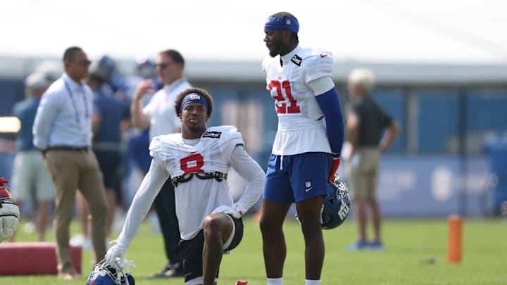 Aug 4, 2025; East Rutherford, NJ, USA; New York Giants safety Jevon Holland (8) and cornerback Paulson Adebo (21) look on during training camp at Quest Diagnostics Training Center. Aug 4, 2025; East Rutherford, NJ, USA; New York Giants safety Jevon Holland (8) and cornerback Paulson Adebo (21) look on during training camp at Quest Diagnostics Training Center.