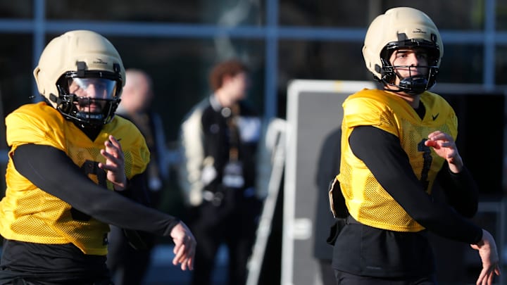 Purdue Boilermakers quarterbacks Malachi Singleton (3) and Evans Chuba (1) throw passes Purdue Boilermakers quarterbacks Malachi Singleton (3) and Evans Chuba (1) throw passes