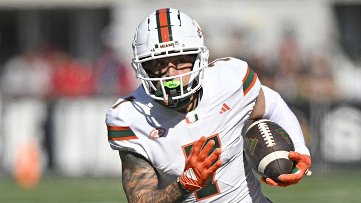 Oct 19, 2024; Louisville, Kentucky, USA;   Miami Hurricanes wide receiver Xavier Restrepo (7) runs the ball against the Louisville Cardinals during the first half at L&N Federal Credit Union Stadium. Miami defeated Louisville 52-45. Mandatory Credit: Jamie Rhodes-Imagn Images