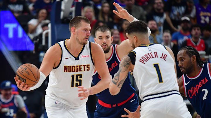 Apr 24, 2025; Inglewood, California, USA; Denver Nuggets center Nikola Jokic (15) passes the ball to forward Michael Porter Jr. (1) against Los Angeles Clippers center Ivica Zubac (40) during the second half of game three in the first round for the 2024 NBA Playoffs at Intuit Dome. Mandatory Credit: Gary A. Vasquez-Imagn Images