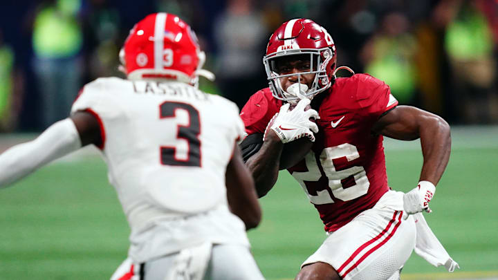 Dec 2, 2023; Atlanta, GA, USA;  Alabama Crimson Tide running back Jam Miller (26) runs against Georgia Bulldogs defensive back Kamari Lassiter (3) in the fourth quarter of the SEC Championship at Mercedes-Benz Stadium. Mandatory Credit: John David Mercer-Imagn Images