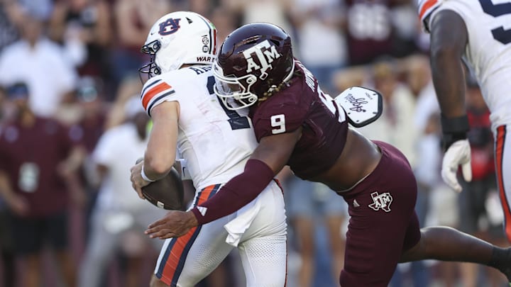 Texas A&M Aggies defensive end Cashius Howell (9) tackes Auburn Tigers quarterback Jackson Arnold (11) during the fourth quarter at Kyle Field.