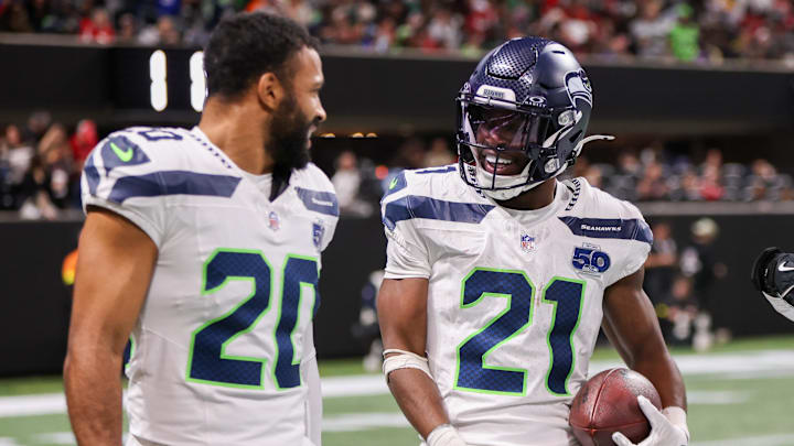 Dec 7, 2025; Atlanta, Georgia, USA; Seattle Seahawks cornerback Devon Witherspoon (21) celebrates with safety Julian Love (20) after an interception against the Atlanta Falcons in the fourth quarter at Mercedes-Benz Stadium.