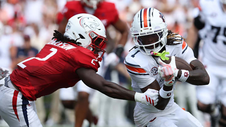 Sep 13, 2025; Auburn, Alabama, USA;  Auburn Tigers wide receiver Eric Singleton Jr. (1) is tackled by South Alabama Jaguars cornerback Jayvon Henderson (2) during the first quarter at Jordan-Hare Stadium. Mandatory Credit: John Reed-Imagn Images