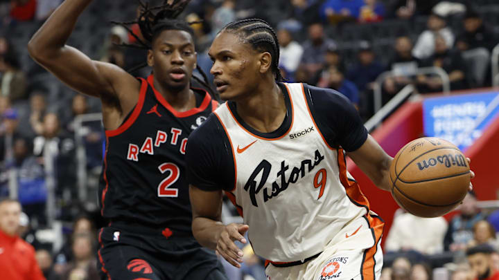 Nov 25, 2024; Detroit, Michigan, USA;  Detroit Pistons forward Ausar Thompson (9) dribbles defended by Toronto Raptors forward Jonathan Mogbo (2) : Rick Osentoski-Imagn Images