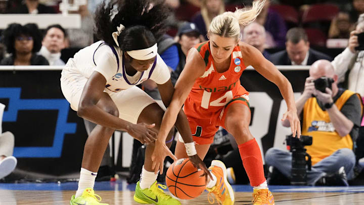 Mar 26, 2023; Greenville, SC, USA; LSU Lady Tigers guard Alexis Morris (45) and Miami Hurricanes guard Haley Cavinder (14) chase the loose ball during the second half in the NCAA Women   s Tournament at Bon Secours Wellness Arena. Mandatory Credit: Jim Dedmon-Imagn Images