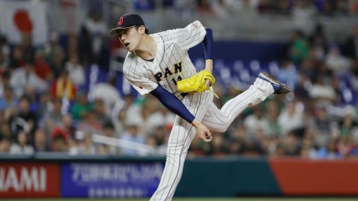 Japan starting pitcher Roki Sasaki (14) delivers a pitch during the first inning against Mexico at LoanDepot Park. 