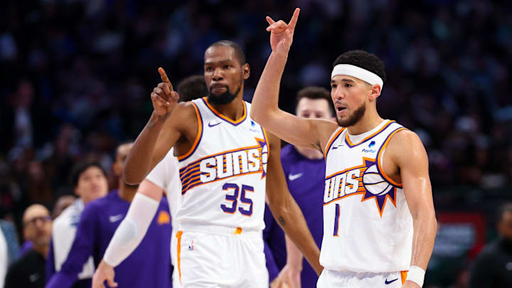 Jan 24, 2024; Dallas, Texas, USA;  Phoenix Suns guard Devin Booker (1) celebrates with Phoenix Suns forward Kevin Durant (35) during the third quarter against the Dallas Mavericks at American Airlines Center. Mandatory Credit: Kevin Jairaj-Imagn Images
