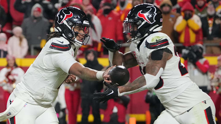 Jan 18, 2025; Kansas City, Missouri, USA; Houston Texans quarterback C.J. Stroud (7)  hands off to running back Joe Mixon (28) against the Kansas City Chiefs during the fourth quarter of a 2025 AFC divisional round game at GEHA Field at Arrowhead Stadium. Mandatory Credit: Denny Medley-Imagn Images