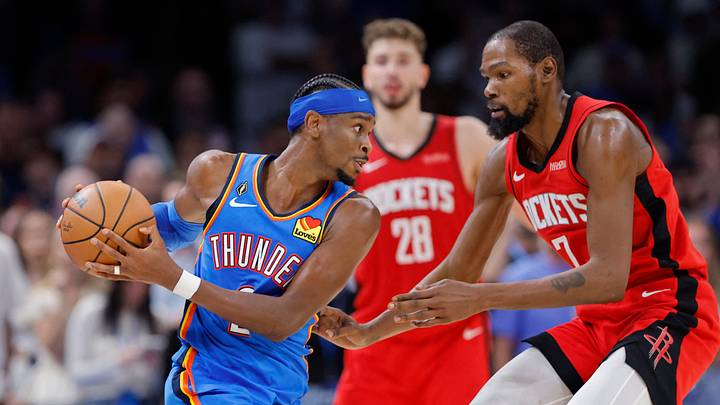 Oct 21, 2025; Oklahoma City, Oklahoma, USA; Oklahoma City Thunder guard Shai Gilgeous-Alexander (2) keeps the ball away from Houston Rockets forward Kevin Durant (7) during the second half at Paycom Center. Mandatory Credit: Alonzo Adams-Imagn Images Oct 21, 2025; Oklahoma City, Oklahoma, USA; Oklahoma City Thunder guard Shai Gilgeous-Alexander (2) keeps the ball away from Houston Rockets forward Kevin Durant (7) during the second half at Paycom Center. Mandatory Credit: Alonzo Adams-Imagn Images