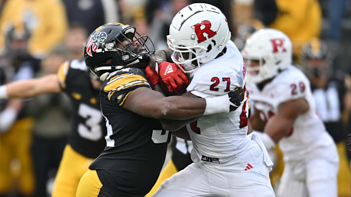 Nov 11, 2023; Iowa City, Iowa, USA; Iowa Hawkeyes linebacker Jay Higgins (34) tackles Rutgers Scarlet Knights running back Samuel Brown V (27) during the second quarter at Kinnick Stadium. Mandatory Credit: Jeffrey Becker-Imagn Images
