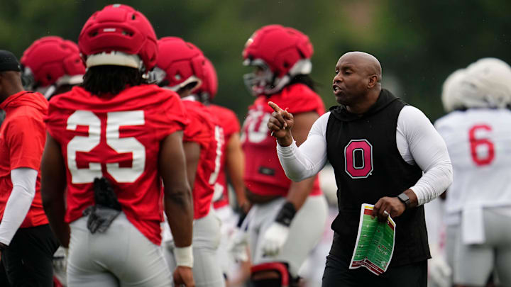 Ohio State Buckeyes running backs coach Carlos Locklyn motions to his team during the first football practice of the season at the Woody Hayes Athletic Center on July 31, 2025.