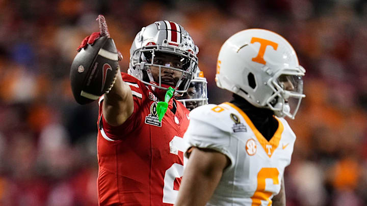 Ohio State Buckeyes wide receiver Emeka Egbuka celebrates a first-down catch behind Tennessee Volunteers defensive back Jalen McMurray.