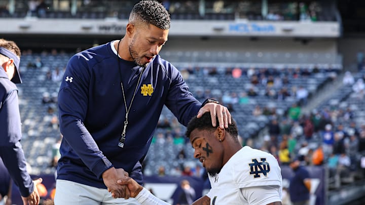 Oct 26, 2024; East Rutherford, New Jersey, USA; Notre Dame Fighting Irish head coach Marcus Freeman greets players before the game against the Navy Midshipmen at MetLife Stadium. Mandatory Credit: Vincent Carchietta-Imagn Images