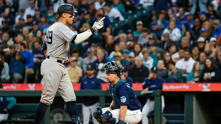 May 30, 2023; Seattle, Washington, USA; New York Yankees center fielder Aaron Judge (99) celebrates after hitting a solo-home run against the Seattle Mariners during the seventh inning at T-Mobile Park. Seattle Mariners catcher Cal Raleigh (29) kneels at right. Mandatory Credit: Joe Nicholson-USA TODAY Sports