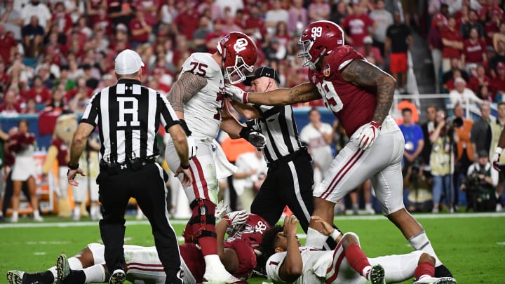 Dec 29, 2018; Miami Gardens, FL, USA; Alabama Crimson Tide defensive lineman Raekwon Davis (99) and Oklahoma Sooners offensive lineman Dru Samia (75) react after Oklahoma Sooners quarterback Kyler Murray (1) is hit by Alabama Crimson Tide defensive lineman Quinnen Williams (92) during the fourth quarter of the 2018 Orange Bowl college football playoff semifinal game at Hard Rock Stadium. Mandatory Credit: Jasen Vinlove-USA TODAY Sports