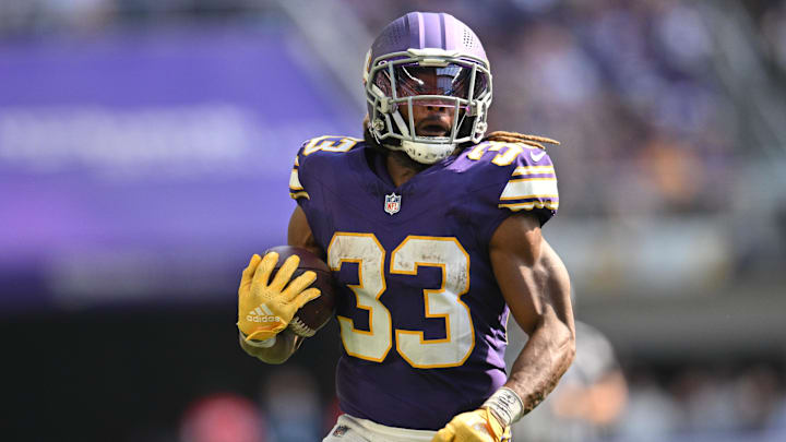 Sep 22, 2024; Minneapolis, Minnesota, USA; Minnesota Vikings running back Aaron Jones (33) runs the ball against the Houston Texans during the fourth quarter at U.S. Bank Stadium. Mandatory Credit: Jeffrey Becker-Imagn Images
