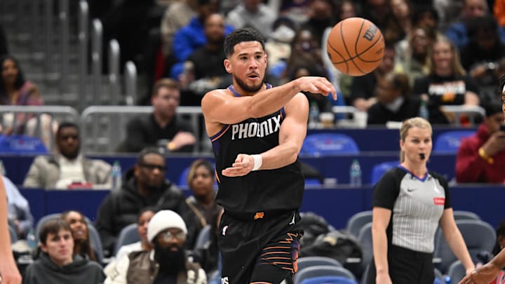 Dec 29, 2025; Washington, District of Columbia, USA;  Phoenix Suns guard Devin Booker (1) passes the ball against the Washington Wizards during the third quarter at Capital One Arena. Mandatory Credit: Rafael Suanes-Imagn Images