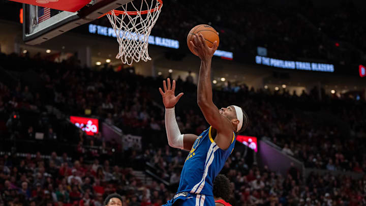 Oct 23, 2024; Portland, Oregon, USA;  Golden State Warriors shooting guard Buddy Hield (7) shoots teh ball over Portland Trailblazers guard Scoot Henderson (00) during the second half at Moda Center. Mandatory Credit: Stephen Brashear-Imagn Images