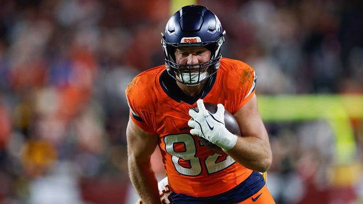 Nov 30, 2025; Landover, Maryland, USA; Denver Broncos tight end Adam Trautman (82) carries the ball after a reception defended by Washington Commanders safety Jeremy Reaves (39) in the second quarter of the game at Northwest Stadium. Mandatory Credit: Peter Casey-Imagn Images Nov 30, 2025; Landover, Maryland, USA; Denver Broncos tight end Adam Trautman (82) carries the ball after a reception defended by Washington Commanders safety Jeremy Reaves (39) in the second quarter of the game at Northwest Stadium. Mandatory Credit: Peter Casey-Imagn Images