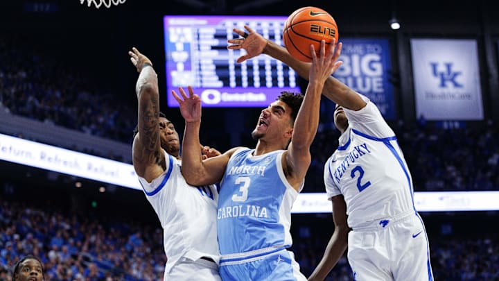 Dec 2, 2025; Lexington, Kentucky, USA; North Carolina Tar Heels guard Derek Dixon (3) goes to the basket against Kentucky Wildcats forward Brandon Garrison (10) and guard Jasper Johnson (2) during the first half at Rupp Arena at Central Bank Center. Mandatory Credit: Jordan Prather-Imagn Images