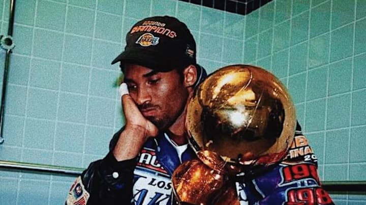 Kobe Bryant Holding The NBA Championship Trophy