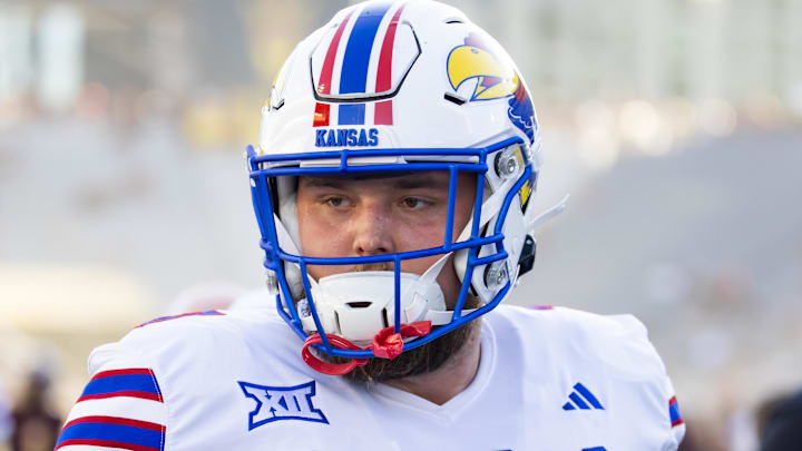 Oct 5, 2024; Tempe, Arizona, USA; Kansas Jayhawks offensive lineman Bryce Cabeldue (77) against the Arizona State Sun Devils at Mountain America Stadium. Mandatory Credit: Mark J. Rebilas-Imagn Images Oct 5, 2024; Tempe, Arizona, USA; Kansas Jayhawks offensive lineman Bryce Cabeldue (77) against the Arizona State Sun Devils at Mountain America Stadium. Mandatory Credit: Mark J. Rebilas-Imagn Images
