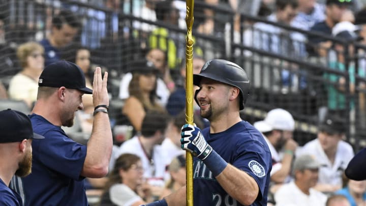 Seattle Mariners outfielder Luke Raley (left) hands catcher Cal Raleigh the trident after he hit a home run against the Chicago White Sox on Saturday at Guaranteed Rate Field. Seattle Mariners outfielder Luke Raley (left) hands catcher Cal Raleigh the trident after he hit a home run against the Chicago White Sox on Saturday at Guaranteed Rate Field.