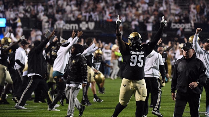 Colorado Buffaloes defensive tackle Tawfiq Thomas celebrates as fans rush the field following an overtime win over the Baylor Bears.