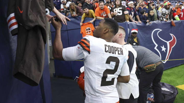 Dec 24, 2023; Houston, Texas, USA; Cleveland Browns wide receiver Amari Cooper (2) signs autographs for fans after the game against the Houston Texans at NRG Stadium. Mandatory Credit: Troy Taormina-USA TODAY Sports