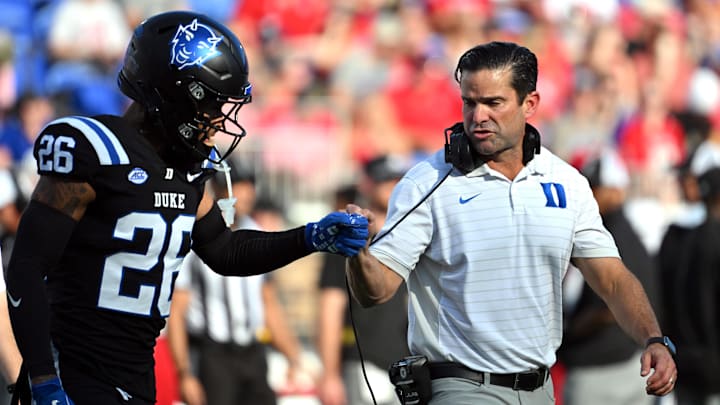 Sep 20, 2025; Durham, North Carolina, USA;  Duke Blue Devils head coach Manny Diaz interacts with safety Ma'khi Jones (26) during the first quarter against the NC State Wolfpack at Wallace Wade Stadium. Mandatory Credit: Zachary Taft-Imagn Images
