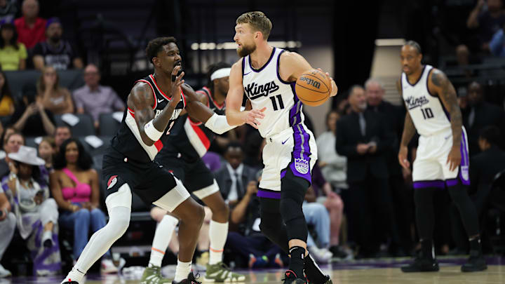 Oct 13, 2024; Sacramento, California, USA;  Sacramento Kings forward Domantas Sabonis (11) controls the ball against Portland Trail Blazers center Deandre Ayton (2) during the first quarter at Golden 1 Center. Mandatory Credit: Sergio Estrada-Imagn Images