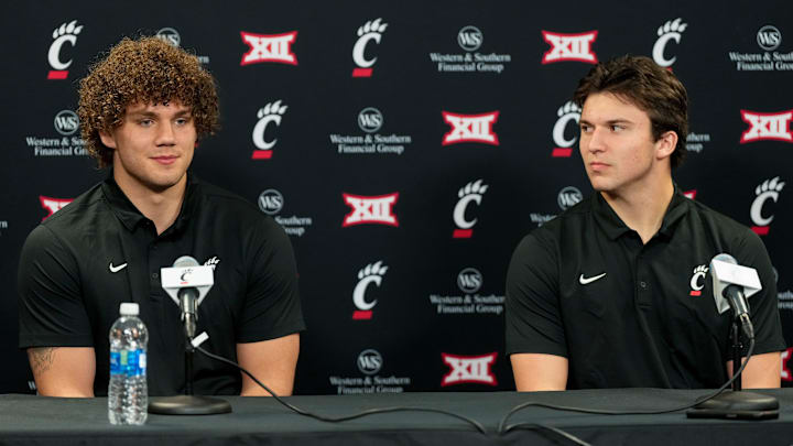 New transfers, tight end Joe Royer (left) and quarterback Brendan Sorsby, take questions during a press conference at the University of Cincinnati s Fifth Third Arena in Cincinnati on Tuesday, Feb. 13, 2024. New transfers, tight end Joe Royer (left) and quarterback Brendan Sorsby, take questions during a press conference at the University of Cincinnati s Fifth Third Arena in Cincinnati on Tuesday, Feb. 13, 2024.