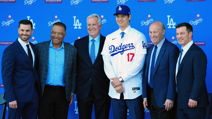 Dec 14, 2023; Los Angeles, CA, USA; From left Brandon Gomes, Dave Roberts, Mark Walter, Shohei Ohtani, Stan Kasten and Andrew Friedman pose for a photo at Ohtani's introductory press conference at Dodger Stadium. Mandatory Credit: Kirby Lee-Imagn Images Dec 14, 2023; Los Angeles, CA, USA; From left Brandon Gomes, Dave Roberts, Mark Walter, Shohei Ohtani, Stan Kasten and Andrew Friedman pose for a photo at Ohtani's introductory press conference at Dodger Stadium. Mandatory Credit: Kirby Lee-Imagn Images