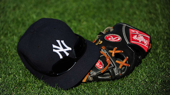 July 7, 2010; Oakland, CA, USA; A New York Yankees hat and glove lay on the grass during batting practice before the game against the Oakland Athletics at Oakland-Alameda County Coliseum. The Yankees defeated the Athletics 6-2. Mandatory Credit: Kyle Terada-Imagn Images
