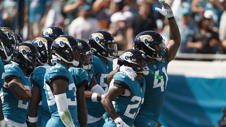 Oct 27, 2024; Jacksonville, Florida, USA; Jacksonville Jaguars cornerback Jarrian Jones (22),cornerback Montaric Brown (30) and defensive end Josh Hines-Allen (41) celebrate an interception against the Green Bay Packers during the second quarter at EverBank Stadium. Mandatory Credit: Morgan Tencza-Imagn Images