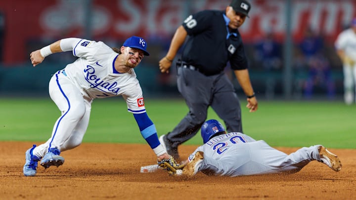 Aug 20, 2025; Kansas City, Missouri, USA;  Kansas City Royals shortstop Bobby Witt Jr. (7) tags out Texas Rangers shortstop Ezequiel Duran (20) at second base during the sixth inning at Kauffman Stadium. Mandatory Credit: William Purnell-Imagn Images