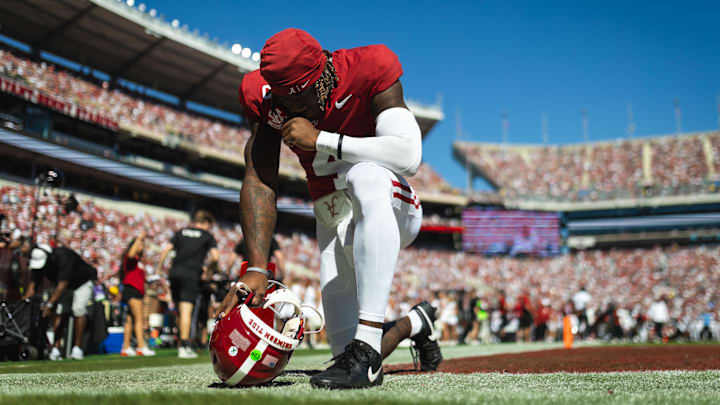 Oct 12, 2024; Tuscaloosa, Alabama, USA; Alabama Crimson Tide quarterback Jalen Milroe (4) prays on the field before the start of the game at Bryant-Denny Stadium. Mandatory Credit: Will McLelland-Imagn Images