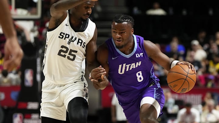 Jul 14, 2025; Las Vegas, NV, USA;  Utah Jazz guard Isaiah Collier (8) drives the ball against San Antonio Spurs forward David Jones-Garcia (25) during the first half of a NBA basketball game at the Thomas & Mack Center. Mandatory Credit: Lucas Peltier-Imagn Images