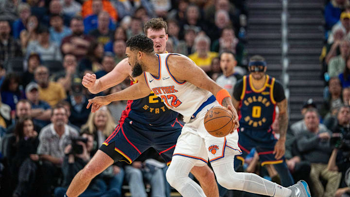 Mar 15, 2025; San Francisco, California, USA; New York Knicks center Karl-Anthony Towns (32) drives to the net against Golden State Warriors center Quinten Post (21) during the fourth quarter at Chase Center. Mandatory Credit: Neville E. Guard-Imagn Images